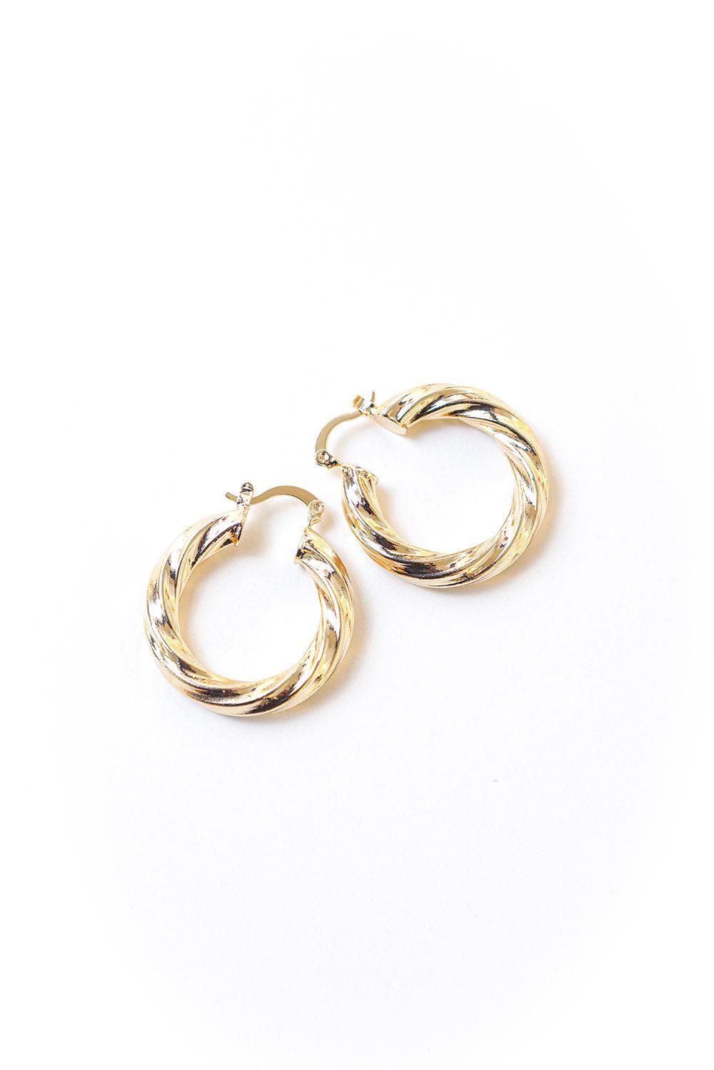 Gold tone twisted huggie earrings with secure hinge enclosure. 35mm diamter