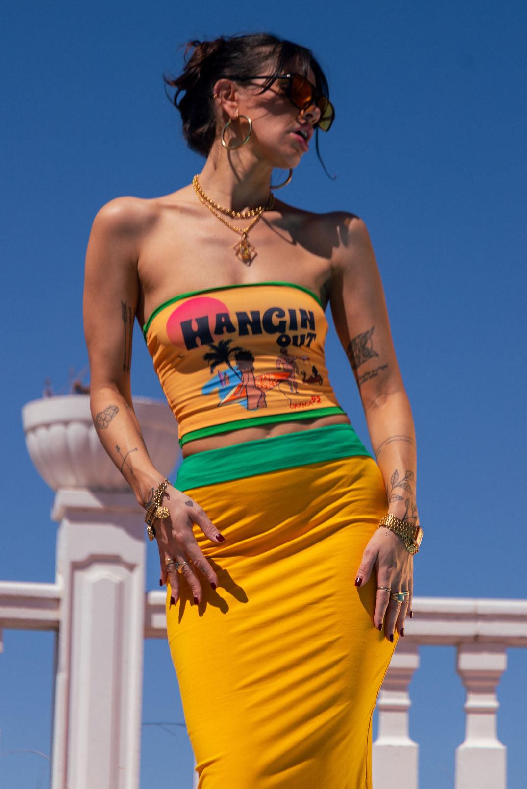 girl in sunshine wearing graphic yellow boob tube and coordinating maxi skirt