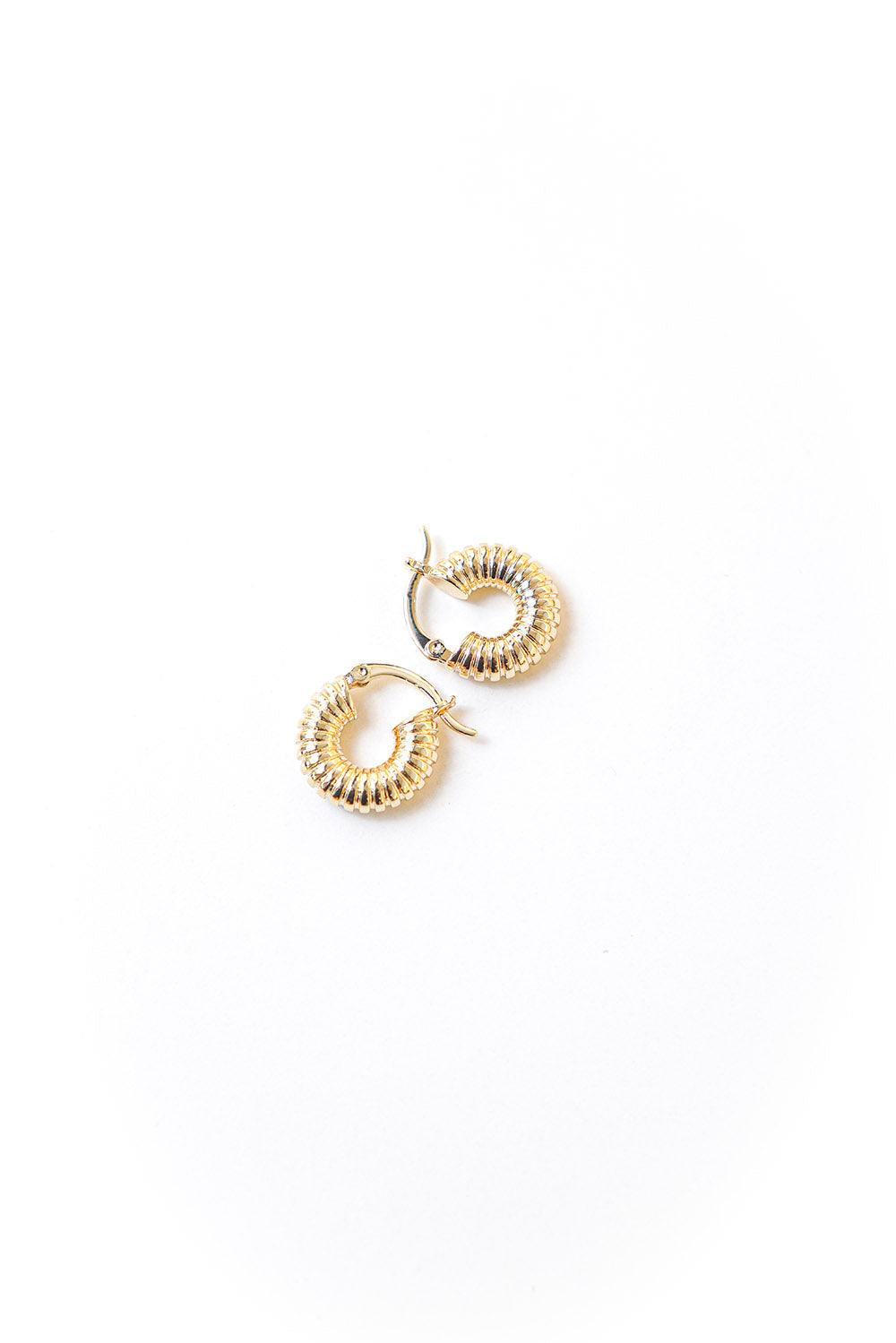 Gold tone twisted huggie earrings with secure hinge enclosure. 20mm diameter